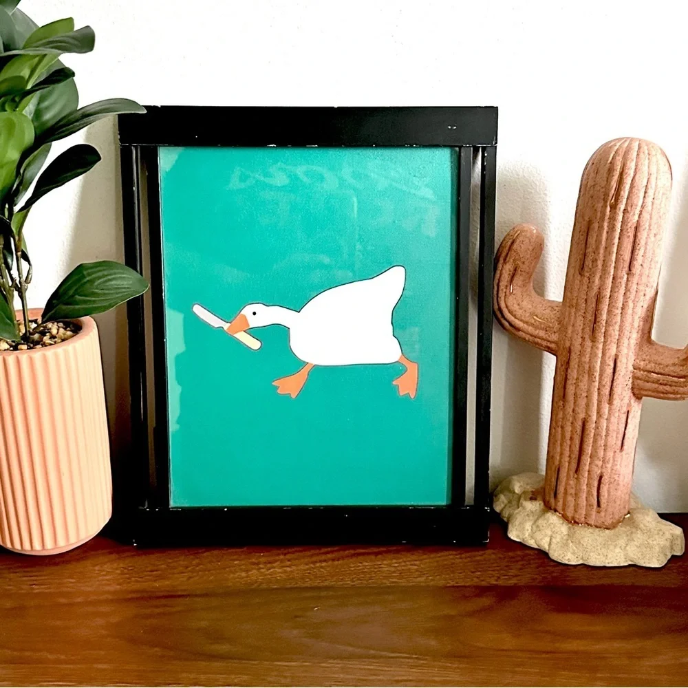 Silly Goose with a Butter Knife Green Canvas Print Black Framed Quirky Wall Art